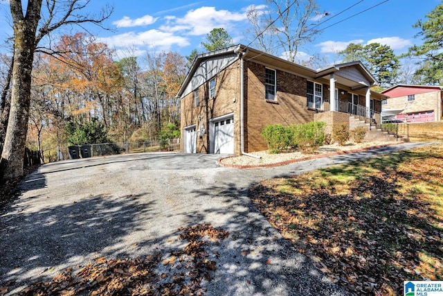 view of home's exterior featuring a porch and a garage