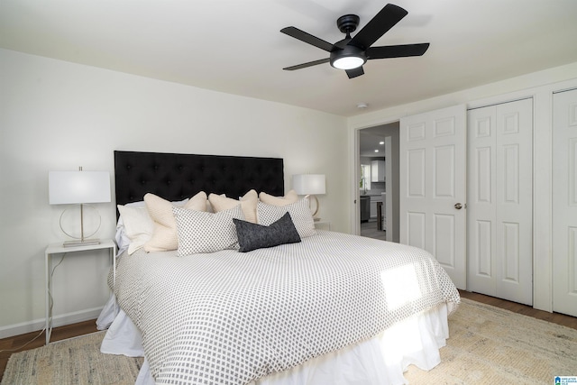 bedroom with ceiling fan, light wood-type flooring, and multiple closets