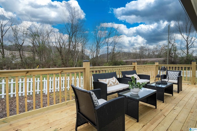 wooden terrace with an outdoor hangout area