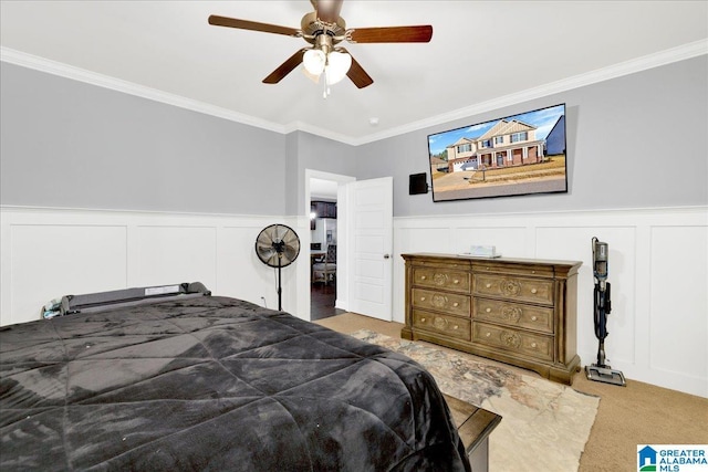 bedroom featuring ceiling fan, crown molding, and carpet