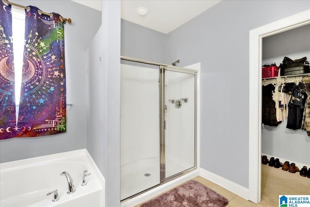 bathroom featuring tile patterned floors and shower with separate bathtub