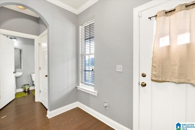 entryway featuring crown molding and dark wood-type flooring