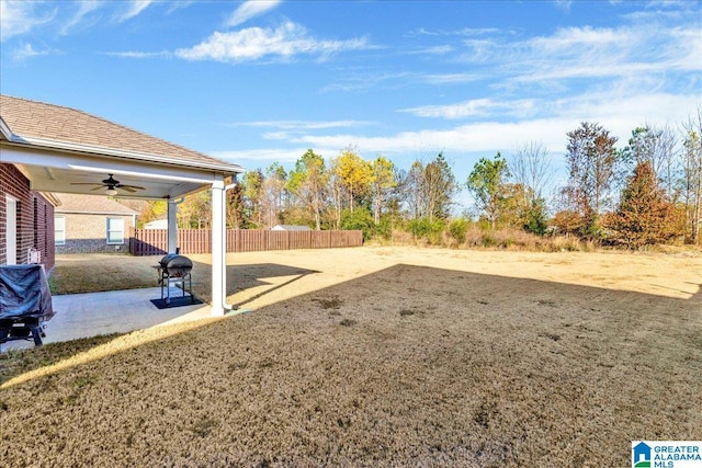 view of yard with ceiling fan and a patio area