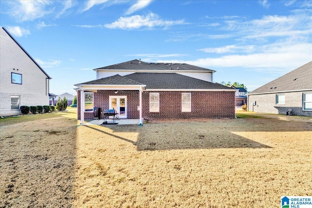 back of house featuring a yard and a patio area