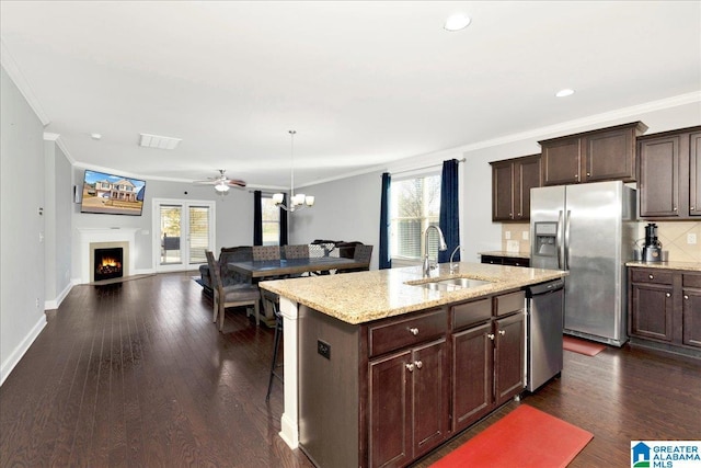 kitchen featuring a healthy amount of sunlight, dark wood-type flooring, sink, and stainless steel appliances