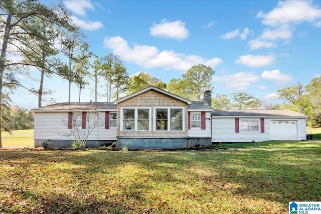 ranch-style home featuring a front lawn and a garage