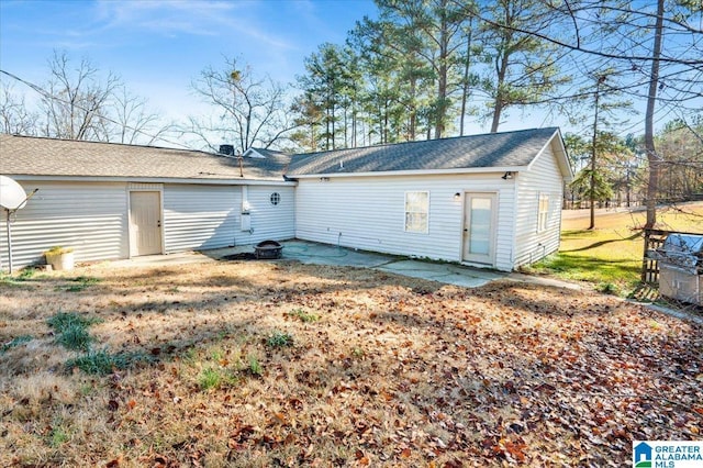 rear view of house featuring a yard