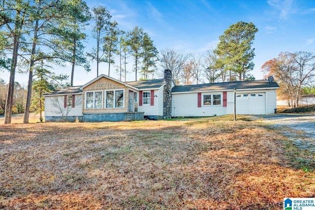 single story home featuring a garage and a front lawn