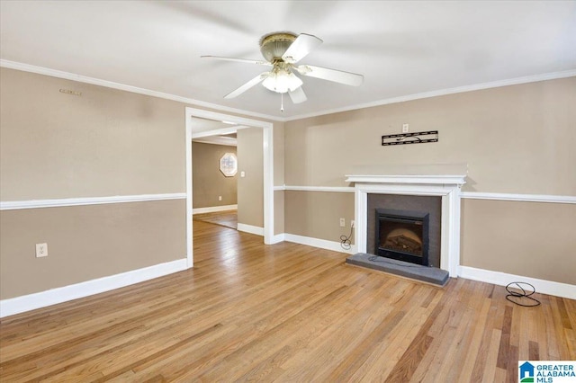 unfurnished living room featuring crown molding, ceiling fan, and light wood-type flooring