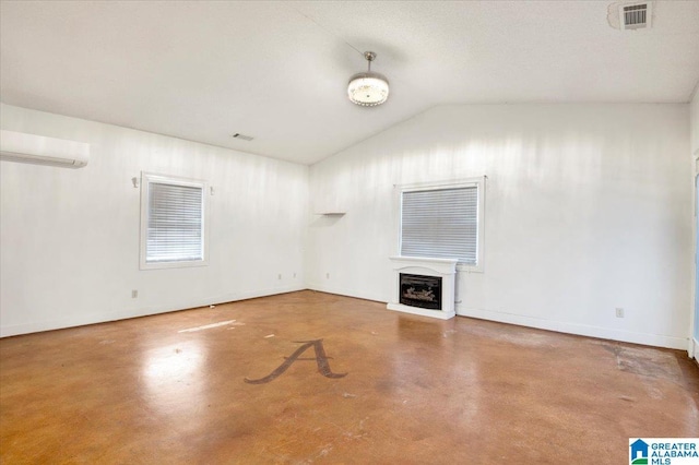 unfurnished living room with an AC wall unit, concrete flooring, and vaulted ceiling