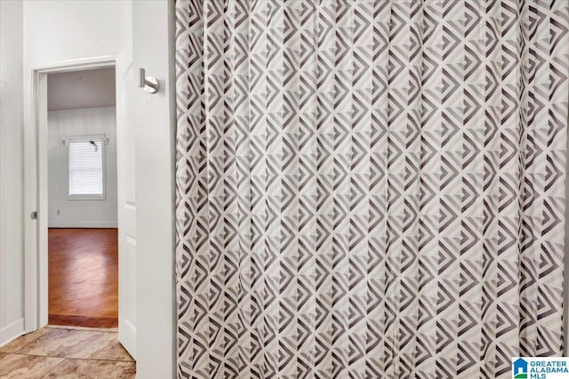 bathroom featuring walk in shower and hardwood / wood-style flooring