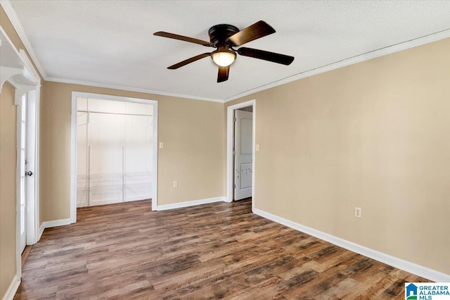 unfurnished bedroom featuring a closet, ceiling fan, hardwood / wood-style floors, and ornamental molding