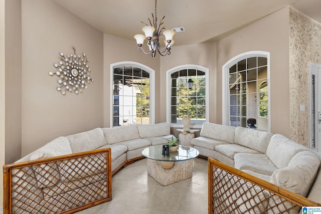 living room featuring a notable chandelier and concrete flooring