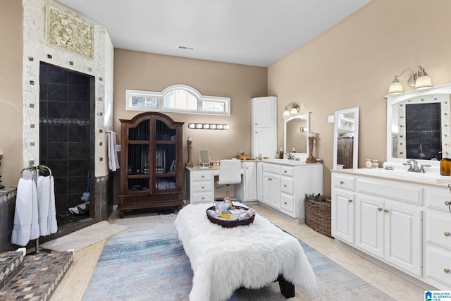 bathroom with tile patterned floors, vanity, and a shower