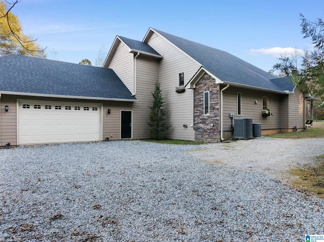 front of property featuring a garage and central air condition unit