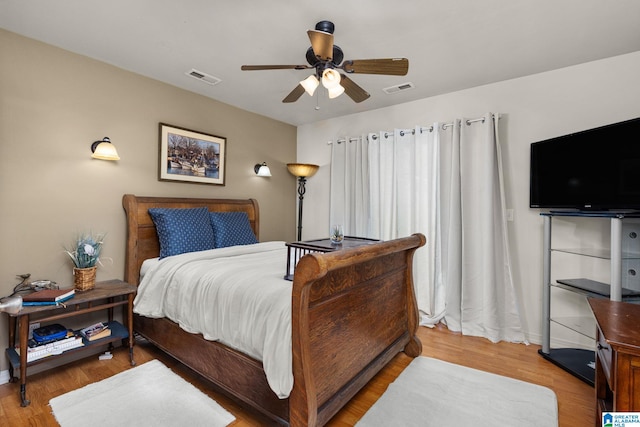 bedroom featuring hardwood / wood-style floors and ceiling fan