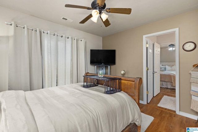 bedroom featuring connected bathroom, ceiling fan, and hardwood / wood-style flooring