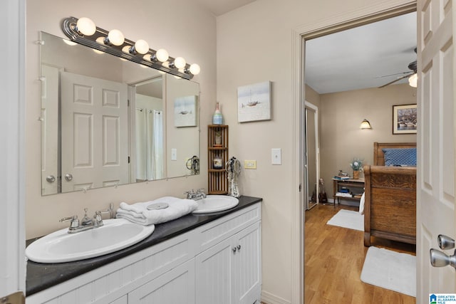 bathroom with vanity, hardwood / wood-style flooring, and ceiling fan