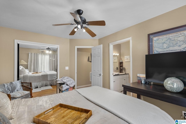 bedroom with ceiling fan, ensuite bathroom, and hardwood / wood-style flooring