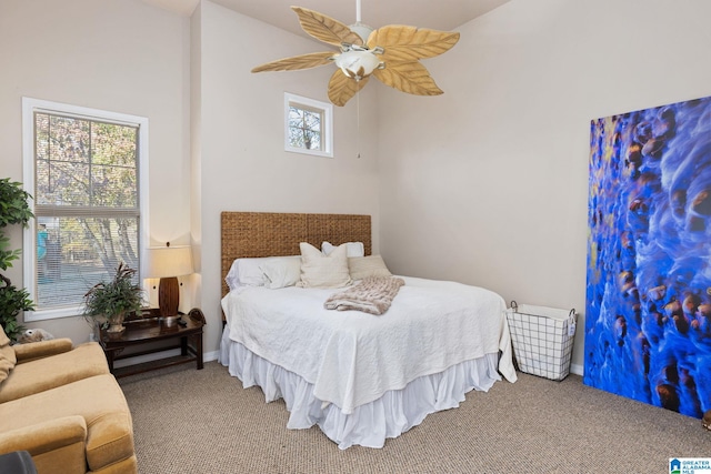 bedroom featuring multiple windows, ceiling fan, and carpet