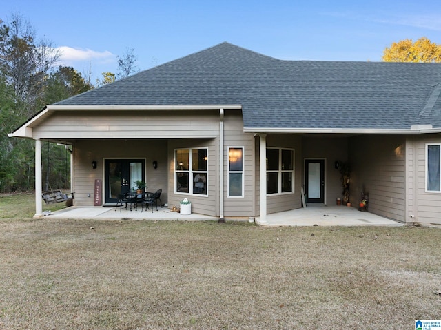 back of property featuring a yard and a patio area