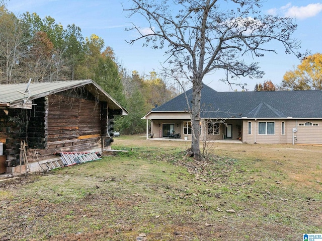 rear view of house with a yard