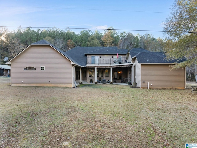 back of property with a patio and a lawn