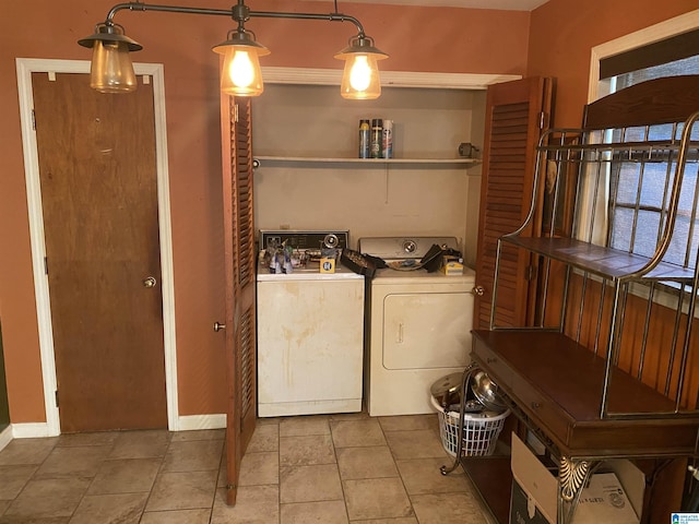 laundry area featuring light tile patterned floors and washing machine and clothes dryer