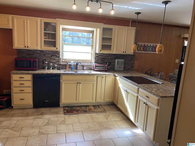 kitchen with hanging light fixtures, tasteful backsplash, sink, and black appliances