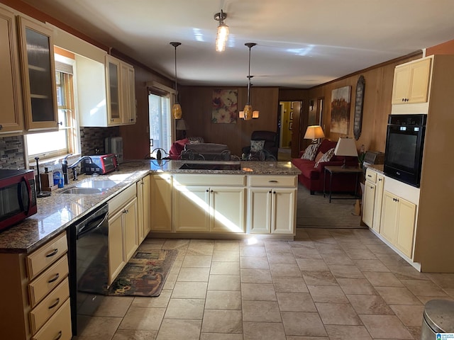 kitchen with sink, cream cabinets, decorative light fixtures, decorative backsplash, and black appliances