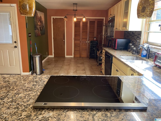 kitchen featuring dishwasher, sink, tasteful backsplash, pendant lighting, and stainless steel stovetop