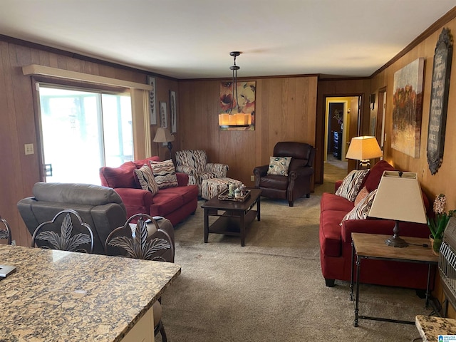 living room with carpet, ornamental molding, and wood walls