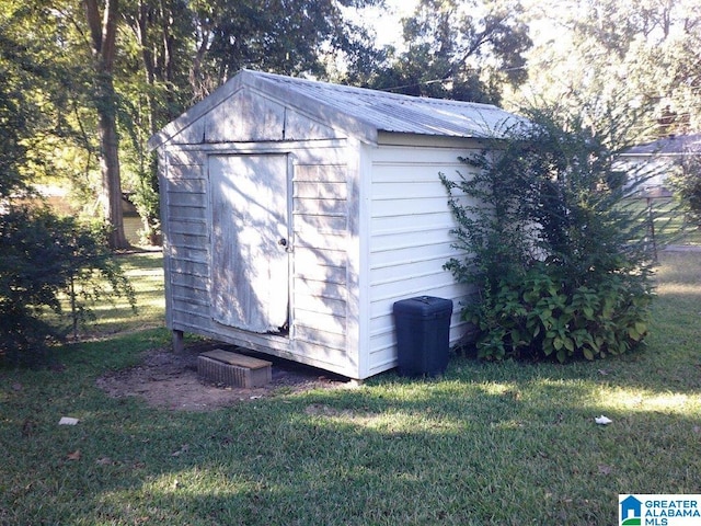 view of outdoor structure featuring a lawn