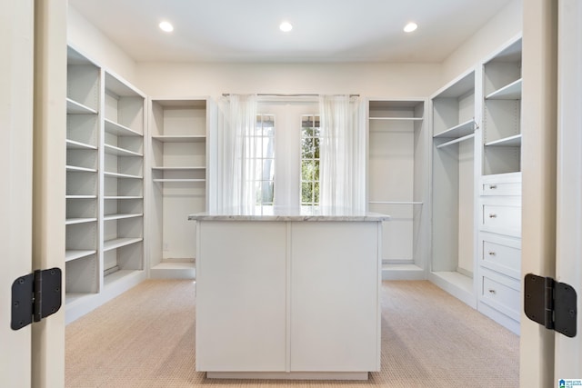 spacious closet featuring light carpet