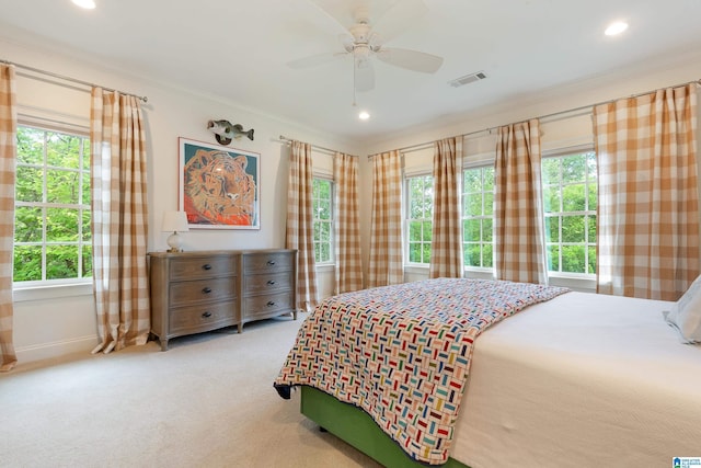 bedroom featuring multiple windows, ceiling fan, and ornamental molding