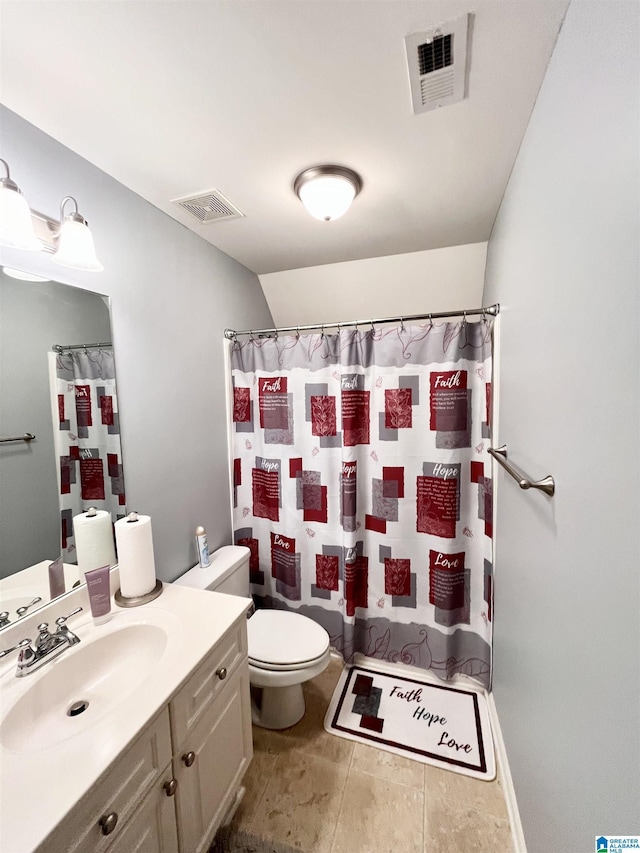 bathroom with tile patterned floors, vanity, toilet, and walk in shower