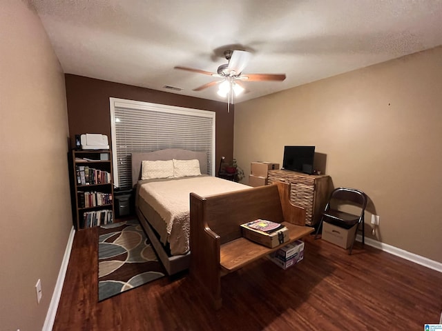 bedroom featuring ceiling fan and dark wood-type flooring