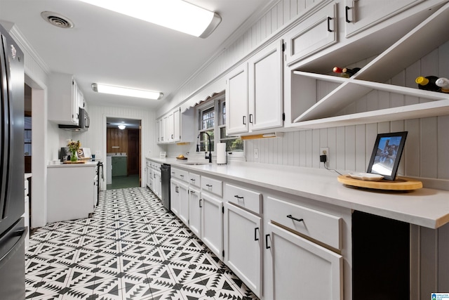 kitchen with white cabinets, ornamental molding, and sink