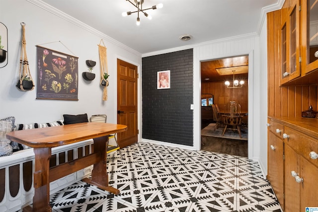 office area with wood walls, light hardwood / wood-style floors, ornamental molding, and an inviting chandelier