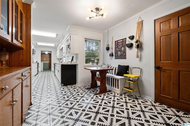 interior space with a notable chandelier, ornamental molding, and light tile patterned floors