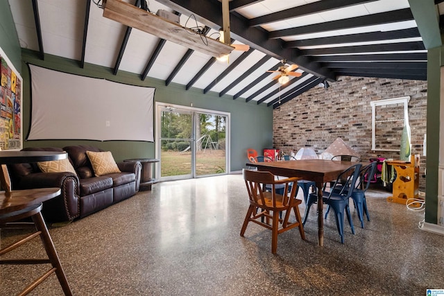 dining room featuring lofted ceiling with beams, ceiling fan, and brick wall