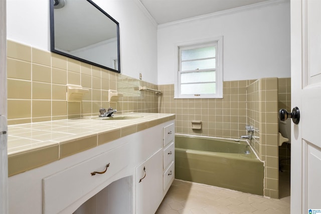 bathroom with tile patterned floors, crown molding, vanity, and tile walls