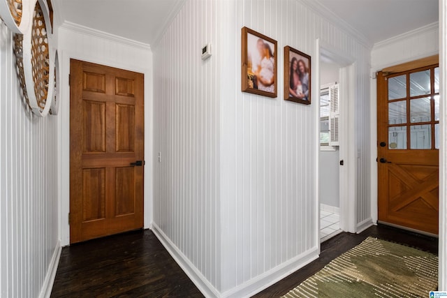 doorway to outside with dark hardwood / wood-style flooring and crown molding