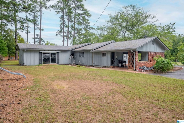 rear view of property with a yard