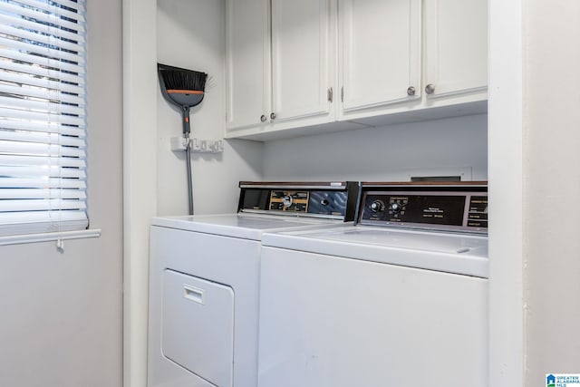 washroom featuring washer and clothes dryer and cabinets