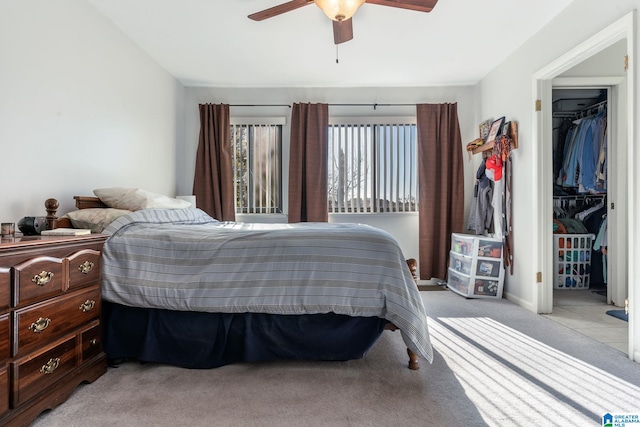 bedroom featuring ceiling fan, a closet, and light carpet