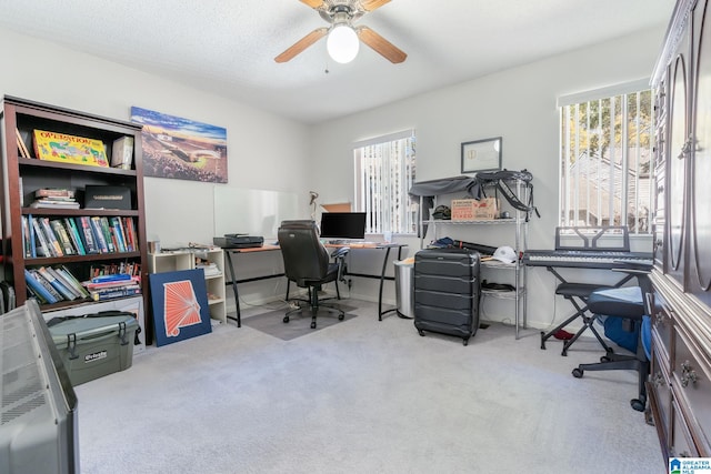 office area featuring ceiling fan, a healthy amount of sunlight, and light colored carpet