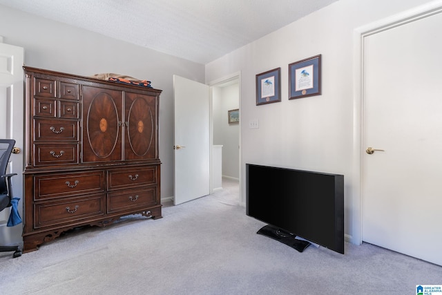 unfurnished bedroom with a textured ceiling and light carpet