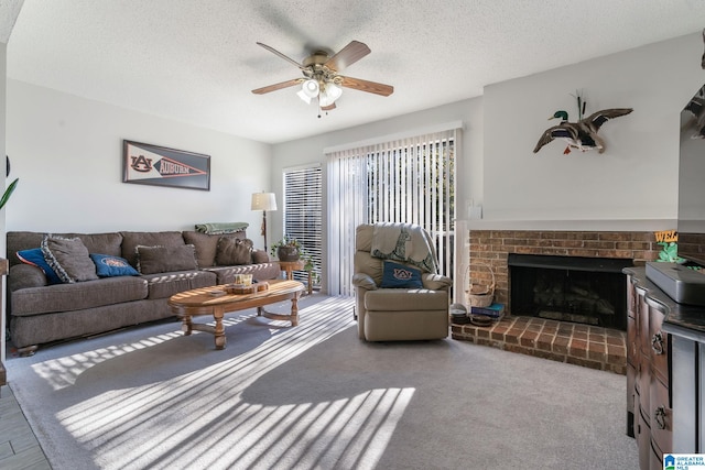 carpeted living room featuring a textured ceiling, a brick fireplace, and ceiling fan