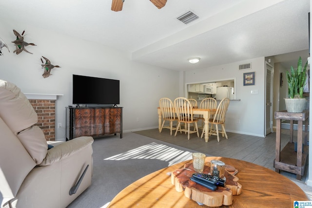 living room with ceiling fan and dark wood-type flooring